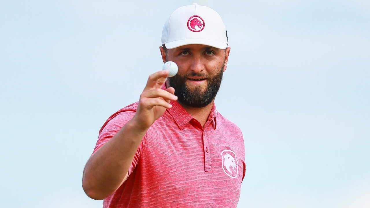 John Rahm holds golf ball